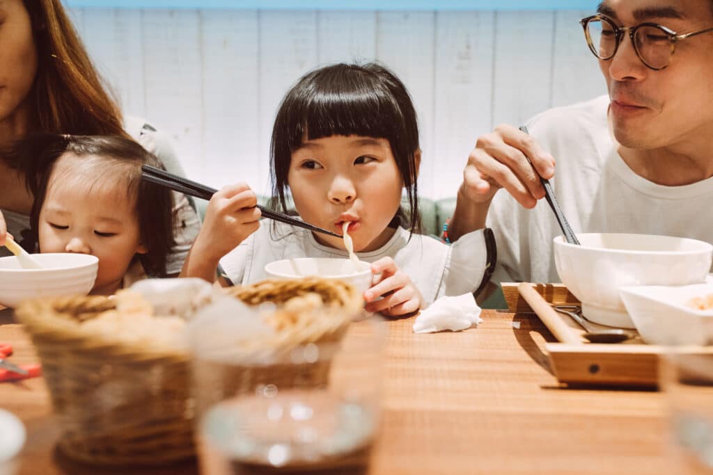lunar new year noodles little girl eating with family, digital red envelope guide