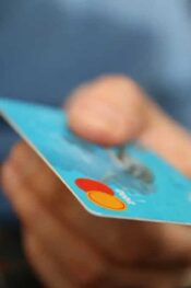 Send money by credit card: person handing a credit card
