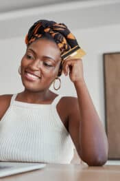 set a safe financial password like your remitly password like this african woman at a laptop