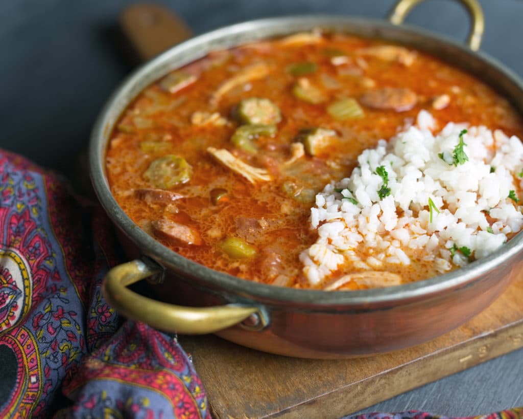 a pot of gumbo with rice and chicken