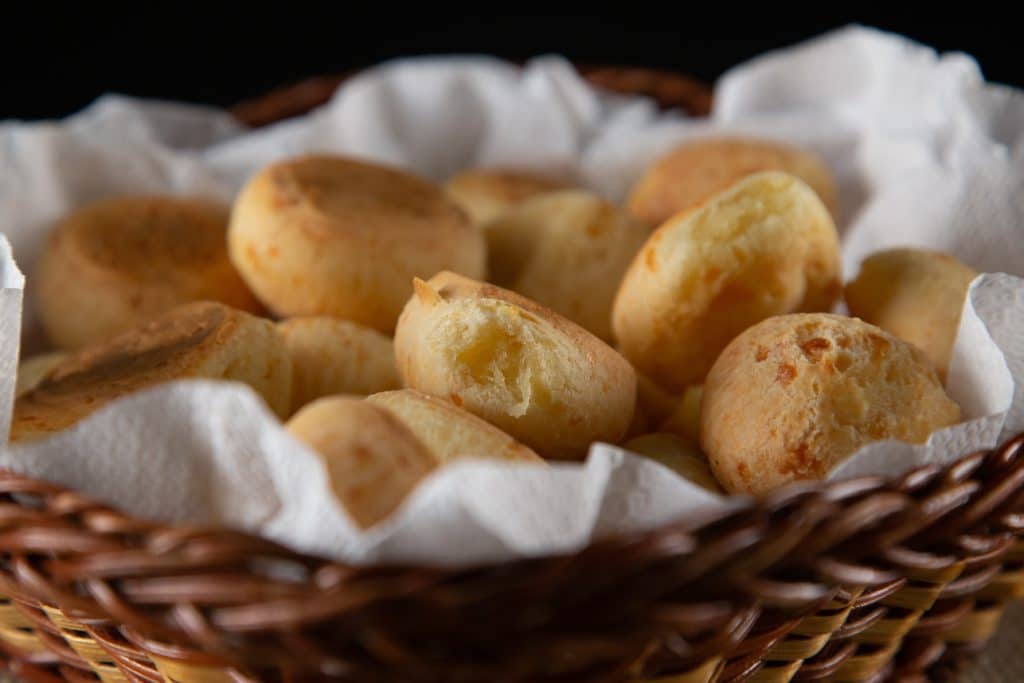 a basket full of bread in a wooden basket