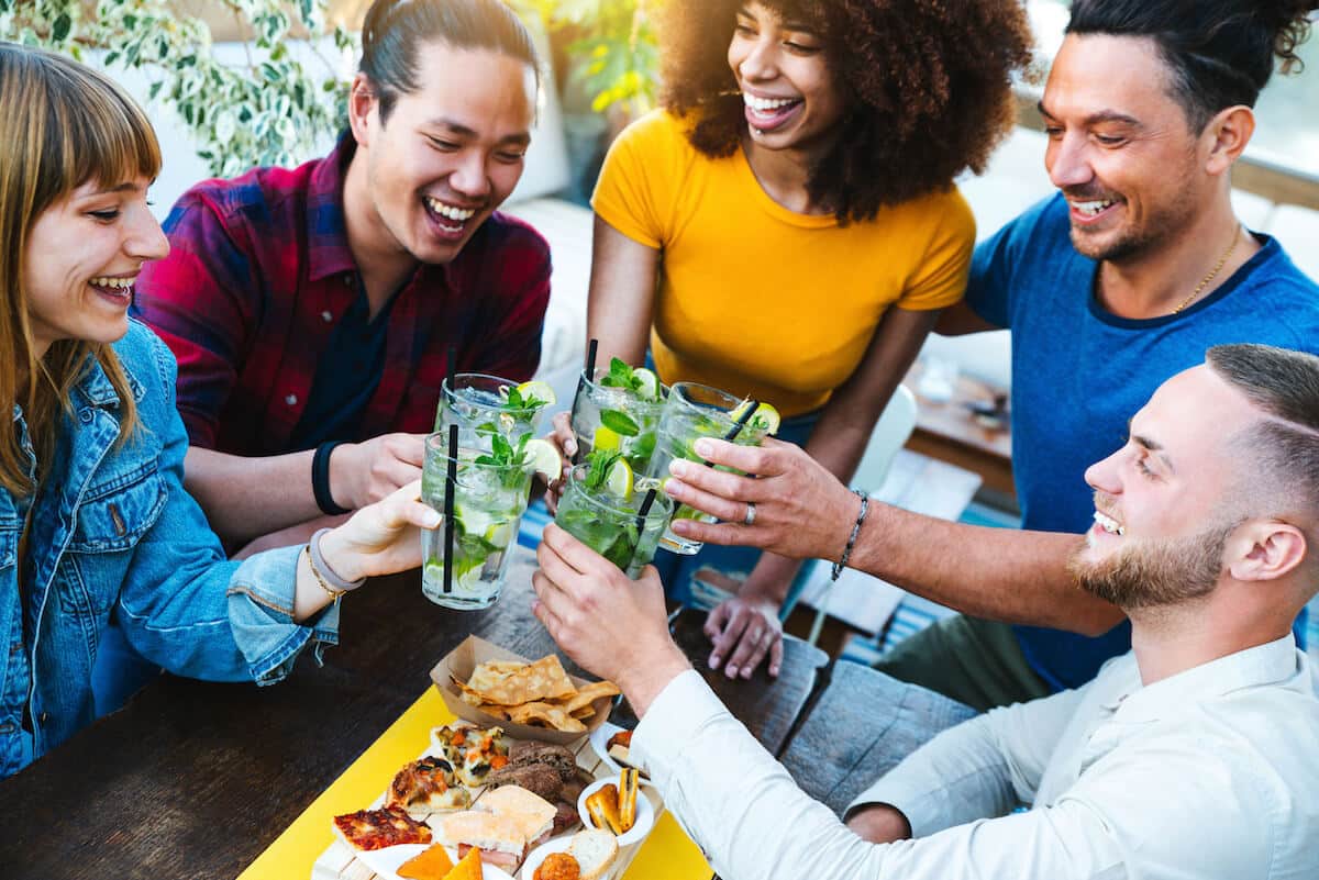 Brazilian dishes: friends happily having a toast