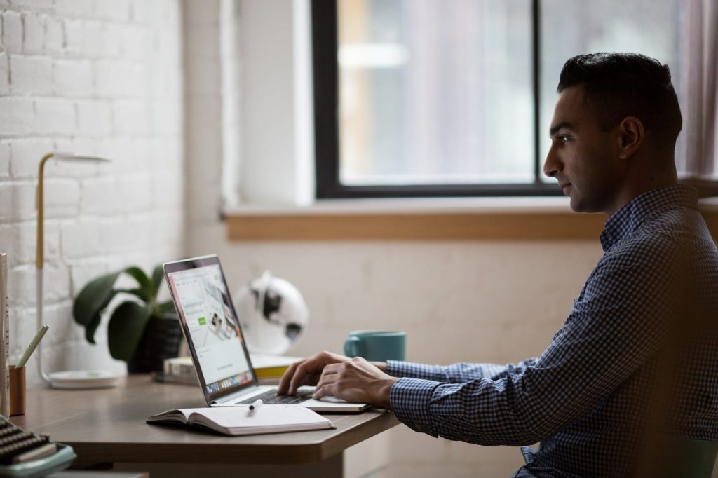 a man working on his laptop at home