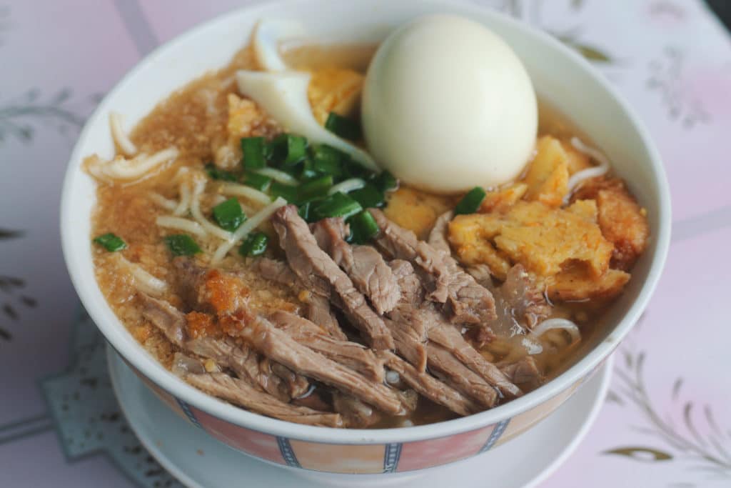 a bowl of ramen with meat and egg