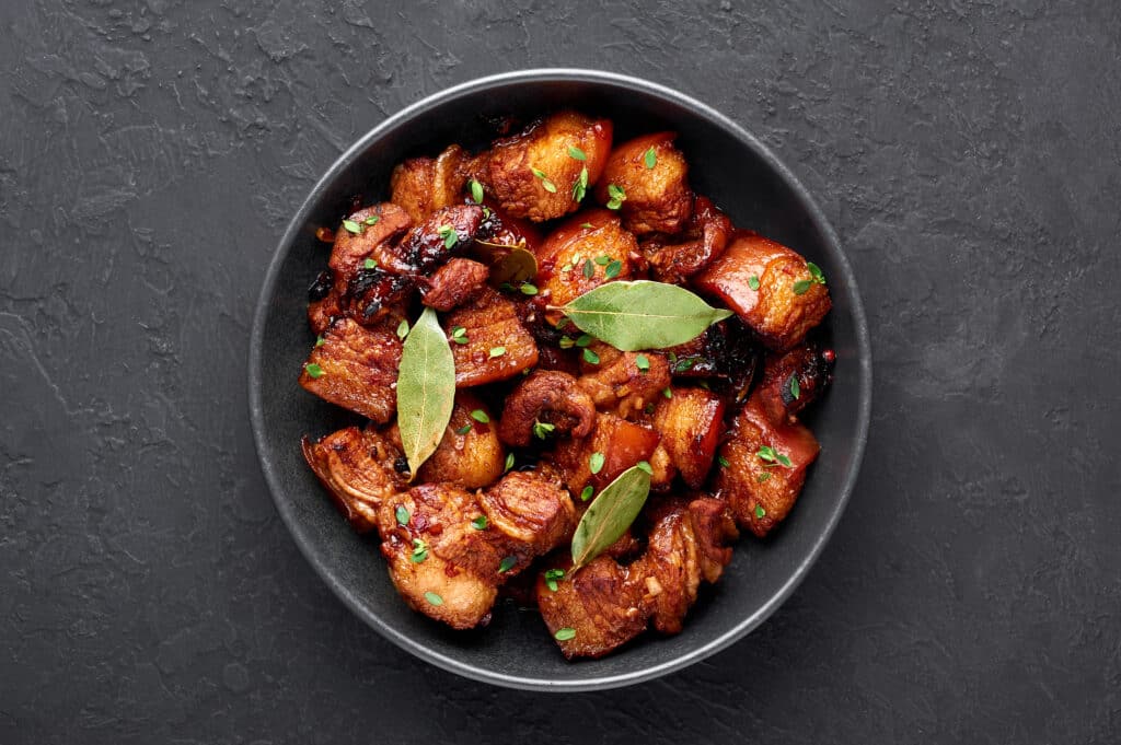 a bowl of fried chicken with sage leaves