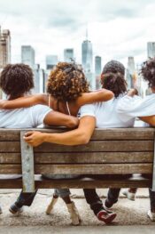 Lowest cost of living in US: group of friends sitting on a bench