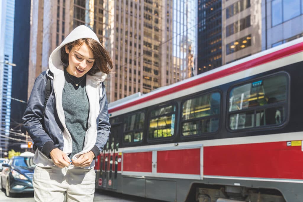 Woman closing her jacket while walking