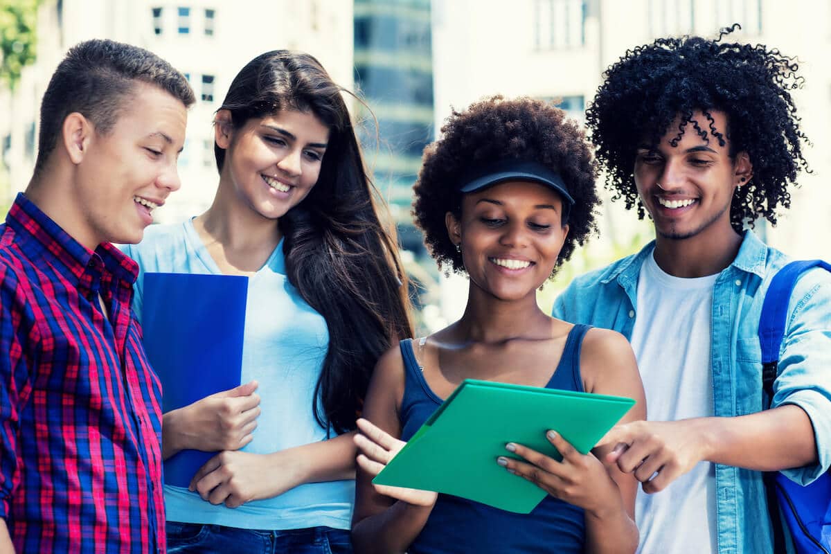 Group of students looking at a folder