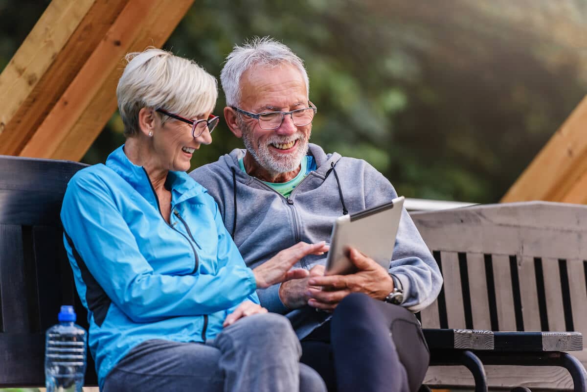 Senior couple happily using a tablet
