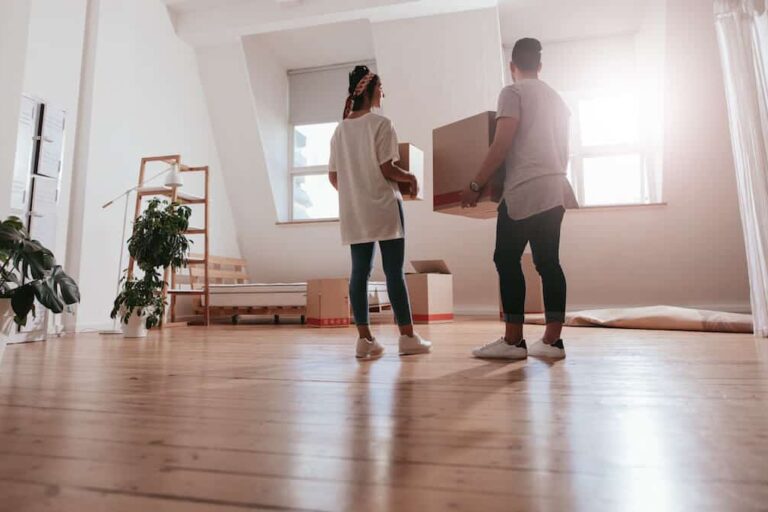 How to move to another country: couple carrying boxes into their new home