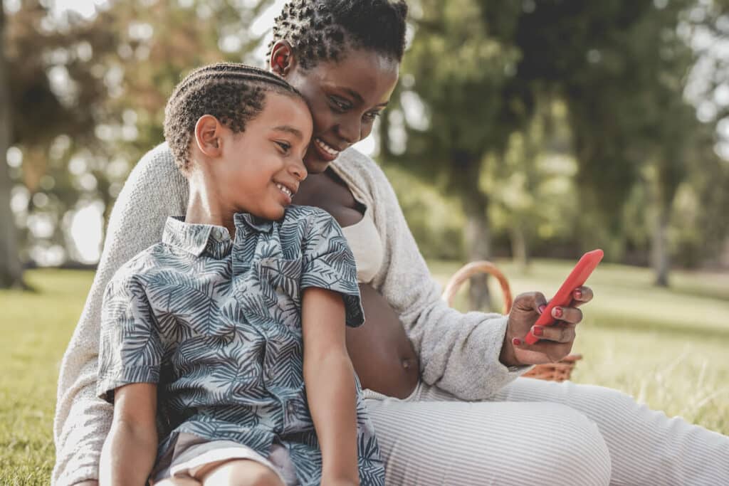 Mother and son watching something on a phone