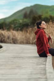 Living in New Zealand: woman sitting on a concrete walkway