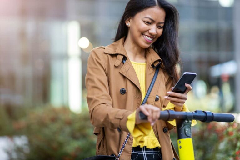 Woman happily using her phone
