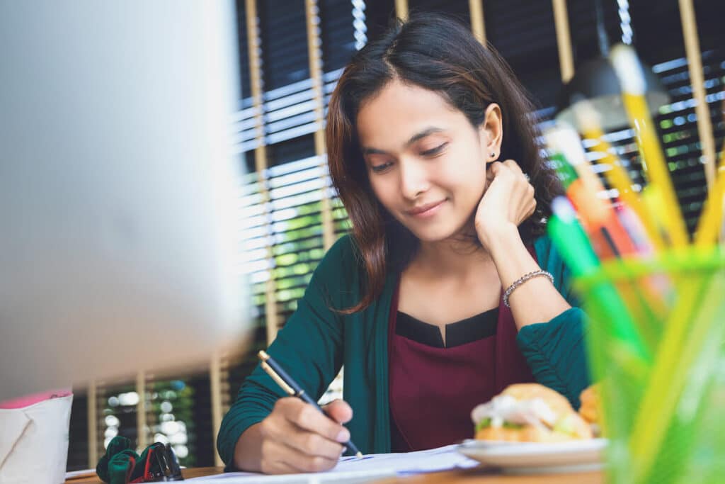 Woman writing on a piece of paper