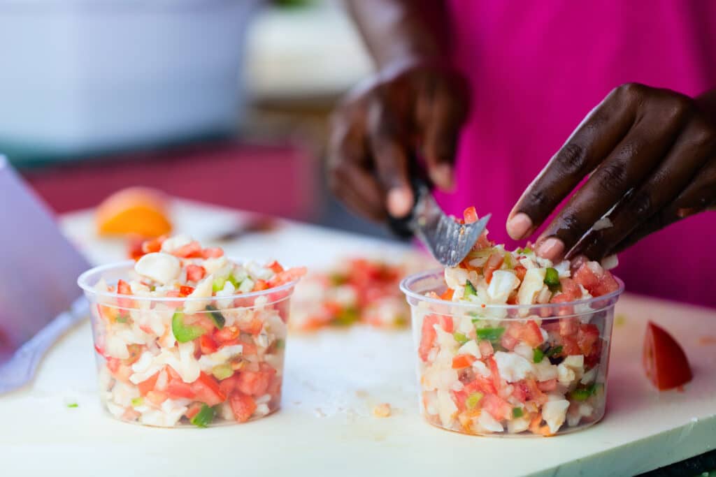 Close up of Bahamian woman making traditional conch salad