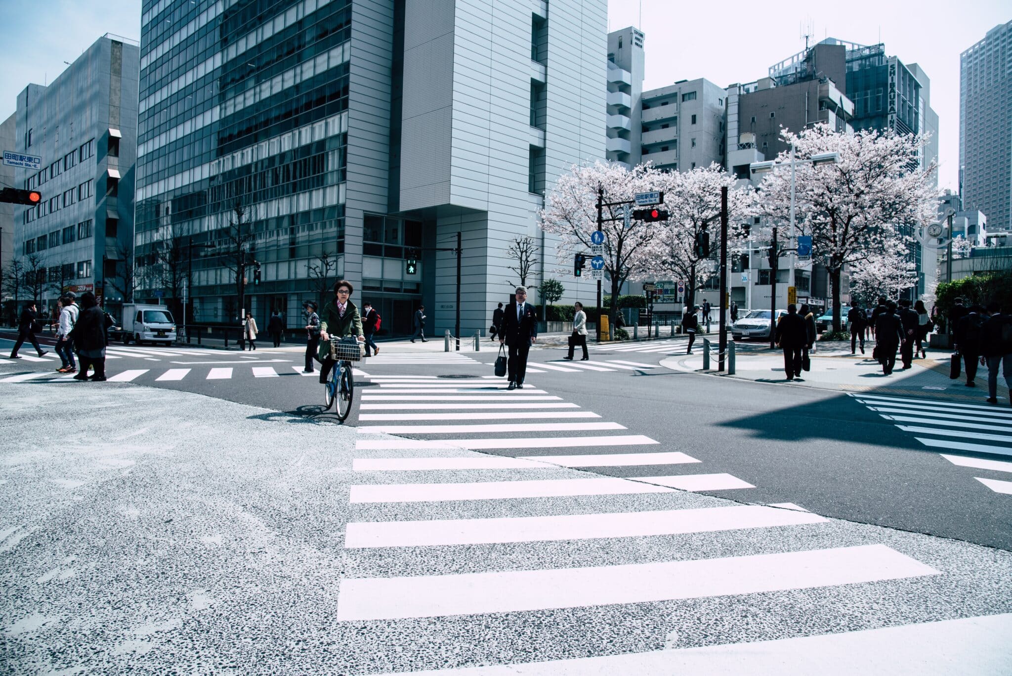 People crossing a street in a modern business district in Tokyo, Japan.