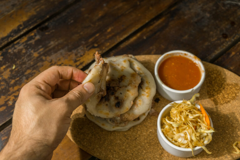 hand picking up pupusa