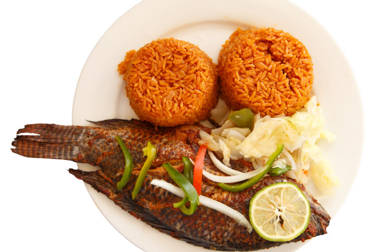 ghanaian jollof rice is on a plate with fish