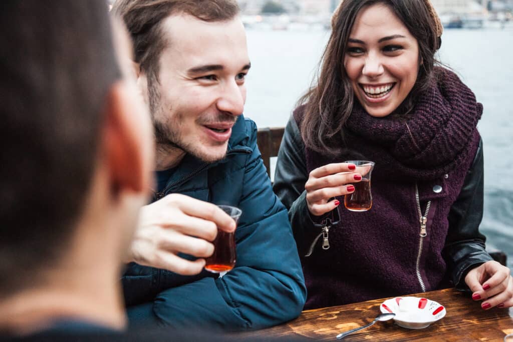 Group of happy friend spending some time together drinking typical tea in Istanbul, Turkey.