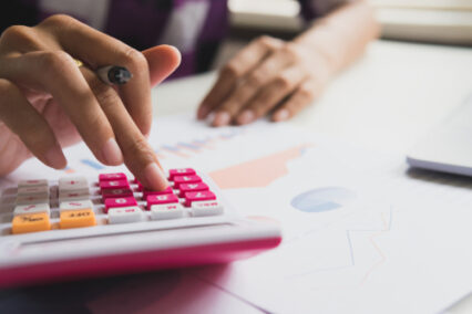 Business woman calculate about cost and doing finance at office, Finance managers task.