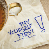 pay yourself first, a reminder of personal finance strategy - a napkin doodle with a tea cup