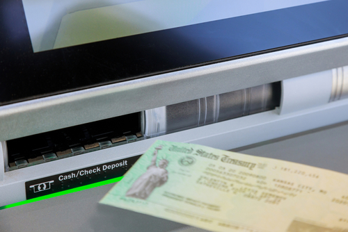 Entering stimulus deposit check to banking using on ATM on machine transfer