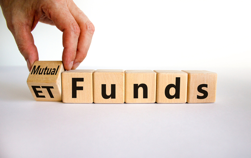 Mutual funds vs ETF symbol - Businessman turns a cube and changes words 'ETF' to 'mutual funds'.