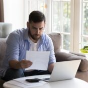 Business man doing paperwork at home