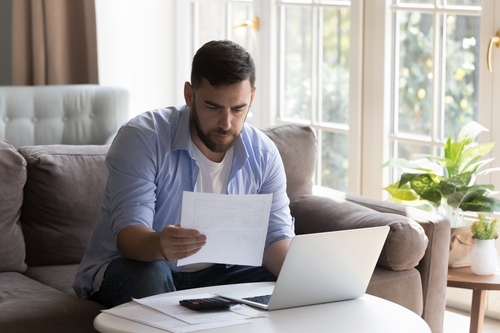 Business man doing paperwork at home