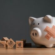 Broken piggy bank with bandages and wooden blocks.