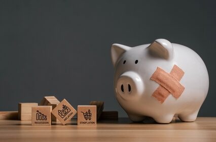 Broken piggy bank with bandages and wooden blocks.