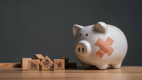 Broken piggy bank with bandages and wooden blocks.