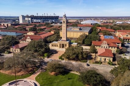 Memorial Tower on LSU campus is a memorial to Louisianans who died in World War I, with Tiger Stadium and the Pete Maravich Assembly center in the background.