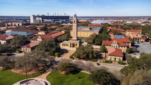 Memorial Tower on LSU campus is a memorial to Louisianans who died in World War I, with Tiger Stadium and the Pete Maravich Assembly center in the background.