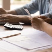 Close up young couple calculating domestic bills.