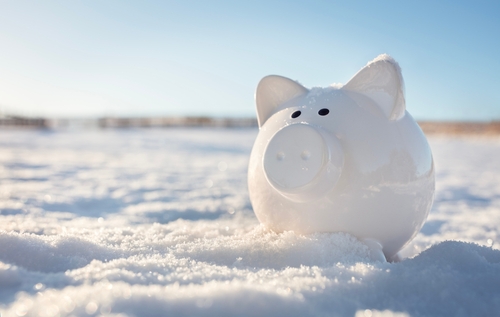 Piggy bank in the snow background, freezing assets, saving for Christmas or Winter holidays