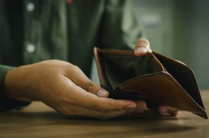 Empty wallet in the hands of a man