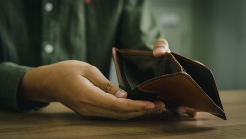 Empty wallet in the hands of a man