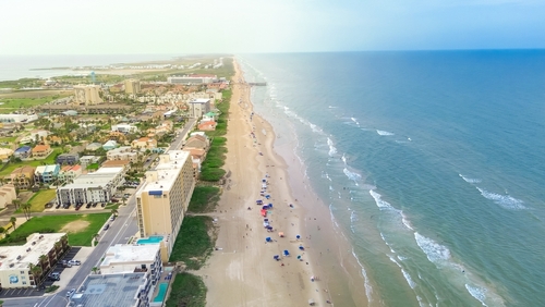 Exquisite barrier South Padre Island tropical beach with condos, hotels, resorts boardwalk and jetty access to sandy shoreline