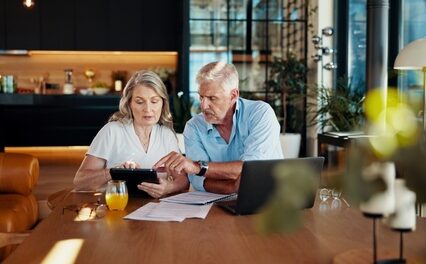Tablet, planning and budget with old couple at home for social benefits, annuity growth and retirement fund. Account balance, online banking and 401k withdrawal with people and profit