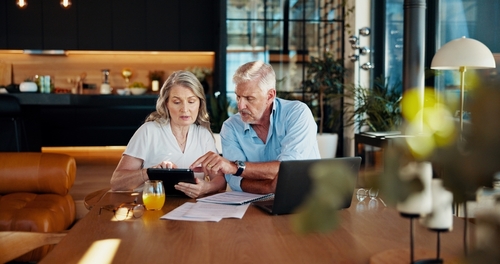 Tablet, planning and budget with old couple at home for social benefits, annuity growth and retirement fund. Account balance, online banking and 401k withdrawal with people and profit