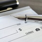 Fountain pen on a blank bank check cheque