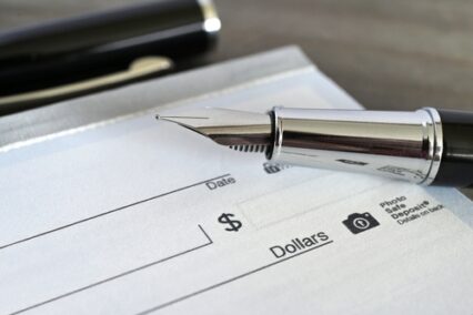 Fountain pen on a blank bank check cheque