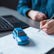 Car dealer signing contract.