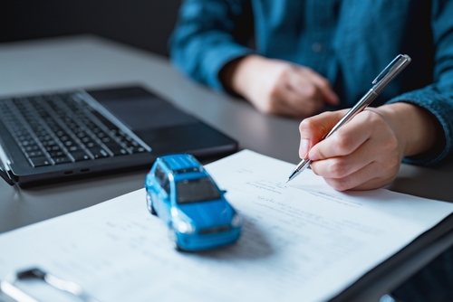 Car dealer signing contract.