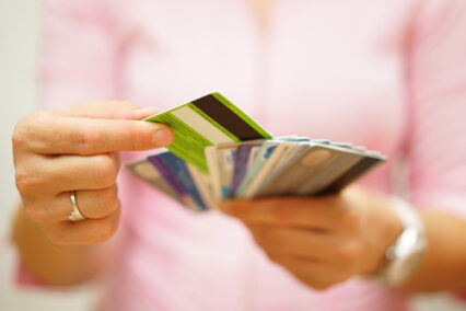 A person choosing a credit card from many