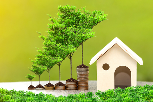 Close up stacking gold coins for growing your money and saving a future for family home.