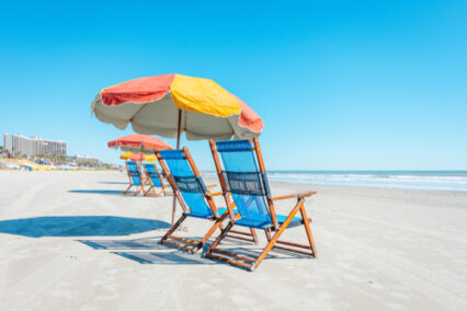 View of colorful beach chairs and umbrellas on Galveston Island Texas.