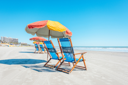 View of colorful beach chairs and umbrellas on Galveston Island Texas.