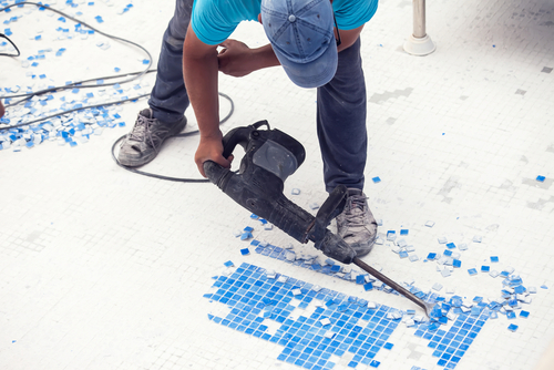Removing tile in the pool, renovation work of swimming pool
